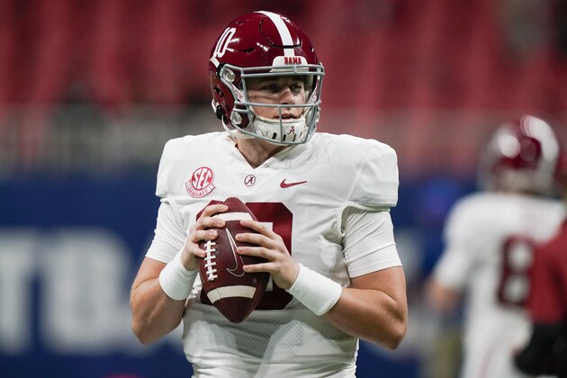 Alabama quarterback Mac Jones (10) warms up before the first half of the Southeastern Conference championship NCAA college football game against Florida, Saturday, Dec. 19, 2020, in Atlanta. Heisman Trophy finalists Mac Jones and DeVonta Smith have been selected to The Associated Press All-America team, Monday, Dec. 28, 2020, leading a contingent of five Alabama players on the first-team offense. (AP Photo/Brynn Anderson)