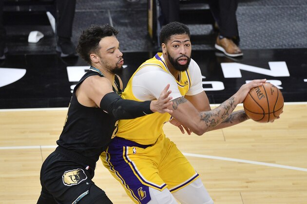 Los Angeles Lakers forward Anthony Davis handles the ball against Memphis Grizzlies guard Dillon Brooks in the first half of an NBA basketball game Tuesday, Jan. 5, 2021, in Memphis, Tenn. (AP Photo/Brandon Dill)
