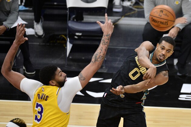 Memphis Grizzlies guard De'Anthony Melton (0) passes the ball ahead of Los Angeles Lakers forward Anthony Davis (3) in the second half of an NBA basketball game Tuesday, Jan. 5, 2021, in Memphis, Tenn. (AP Photo/Brandon Dill)