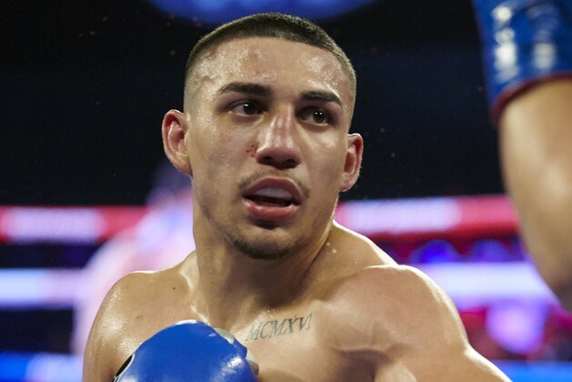 FILE - In this Feb. 2, 2019, file photo, Teofimo Lopez is shown during his lightweight boxing match against Diego Magdaleno, in Frisco, Texas. Brooklyn-born Teofimo Lopez stunned Vasiliy Lomachenko on Saturday, Oct. 17, 2020, to win a unanimous 12-round decision and unify the lightweight titles to join a rare group of boxers of Central American descent to capture a world championship. (AP Photo/Cooper Neill, File)