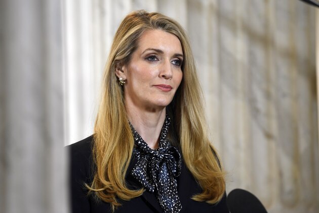 FILE - In this Friday, March 20, 2020, file photo, Sen. Kelly Loeffler, R-Georgia, waits to speak in a television interview on Capitol Hill in Washington. WNBA players have urged people to vote against Atlanta Dream co-owner Loeffler, a Republican U.S. senator running to keep her seat in Georgia. Loeffler, who spoke out publicly against the leagueâ€™s social justice plans and sent a letter to WNBA Commissioner Cathy Engelbert objecting to the initiatives to honor the Black Lives Matter movement once the season began last month, is facing opposition from Raphael Warnock. (AP Photo/Susan Walsh, File)