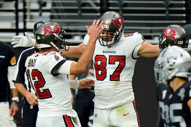 Tampa Bay Buccaneers tight end Rob Gronkowski (87) celebrates with quarterback Tom Brady (12), left, after Gronkowski scored a touchdown against the Las Vegas Raiders during the first half of an NFL football game, Sunday, Oct. 25, 2020, in Las Vegas. (AP Photo/Jeff Bottari)
