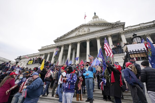 Trump supporters gather outside the Capitol, Wednesday, Jan. 6, 2021, in Washington. As Congress prepares to affirm President-elect Joe Biden's victory, thousands of people have gathered to show their support for President Donald Trump and his claims of election fraud. (AP Photo/Manuel Balce Ceneta)