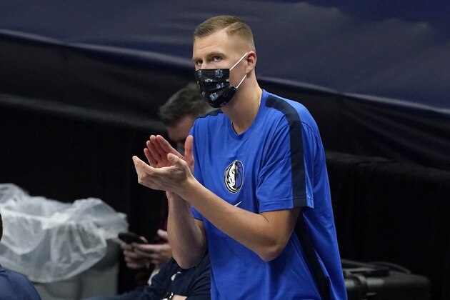 Dallas Mavericks forward Kristaps Porzingis (6) applauds his team effort during a timeout in the second half of an NBA preseason basketball game against the Minnesota Timberwolves in Dallas, Thursday, Dec. 17, 2020. (AP Photo/Tony Gutierrez)