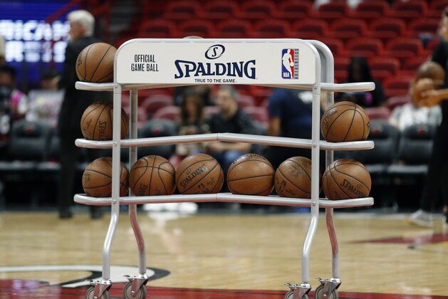 A rack of NBA Spading basketballs sit at mid court prior to the start of an NBA basketball game between the Miami Heat and the Dallas Mavericks, Thursday, March 28, 2019, in Miami. The Heat defeated the Mavericks 105-99. (AP Photo/Joel Auerbach)