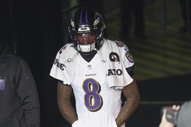 Baltimore Ravens quarterback Lamar Jackson (8) waits to come onto the field before an NFL football game against the Cincinnati Bengals, Sunday, Jan. 3, 2021, in Cincinnati. (AP Photo/Bryan Woolston)
