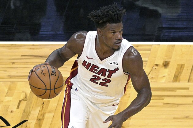 Miami Heat forward Jimmy Butler (22) drives to the basket during the first half of an NBA basketball game against the Orlando Magic, Wednesday, Dec. 23, 2020, in Orlando, Fla. (AP Photo/Phelan M. Ebenhack)