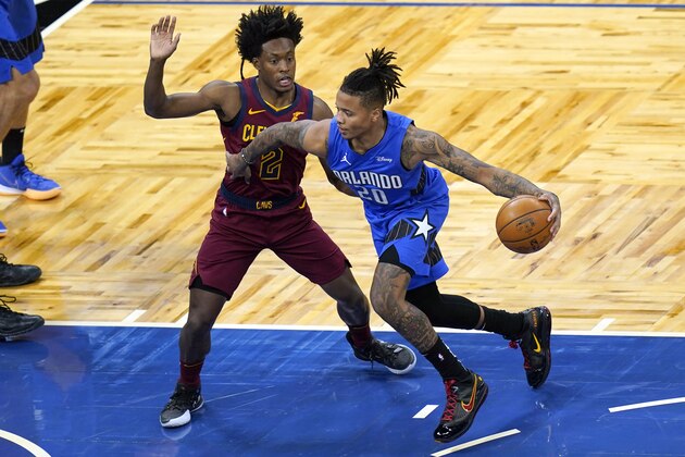Orlando Magic guard Markelle Fultz (20) goes to the basket against Cleveland Cavaliers guard Collin Sexton (2) during the fist half of an NBA basketball game, Wednesday, Jan. 6, 2021, in Orlando, Fla. (AP Photo/John Raoux)