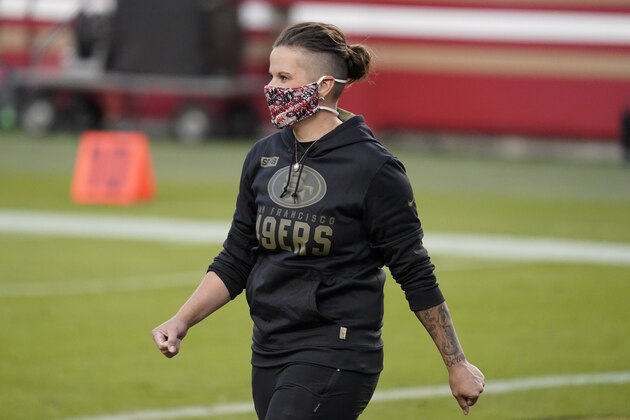 San Francisco 49ers assistant coach Katie Sowers wears Salute to Service clothing before an NFL football game between the 49ers and the Green Bay Packers in Santa Clara, Calif., Thursday, Nov. 5, 2020. (AP Photo/Tony Avelar)