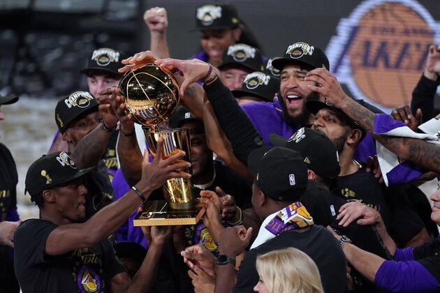 The Los Angeles Lakers players celebrate after the Lakers defeated the Miami Heat 106-93 in Game 6 of basketball's NBA Finals Sunday, Oct. 11, 2020, in Lake Buena Vista, Fla. (AP Photo/Mark J. Terrill)