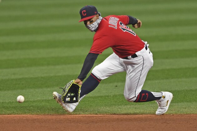 Cleveland Indians' Francisco Lindor (12) fields the ball in the first inning of Game 1 of an American League wild-card baseball series against the against the New York Yankees, Tuesday, Sept. 29, 2020, in Cleveland. (AP Photo/David Dermer)