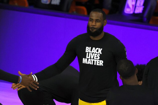 Los Angeles Clippers' LeBron James kneels during the national anthem prior to the NBA basketball game against the Oklahoma City Thunder Wednesday, Aug. 5, 2020, in Lake Buena Vista, Fla. (Kevin C. Cox/Pool Photo via AP)