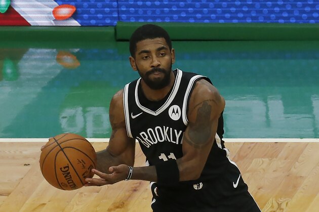 Brooklyn Nets guard Kyrie Irving (11) looks to pass during the first half of an NBA preseason basketball game against the Boston Celtics, Friday, Dec. 18, 2020, in Boston. (AP Photo/Mary Schwalm)