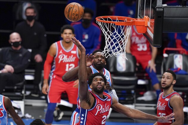 Philadelphia 76ers' Joel Embiid, center, shoots in front of Brooklyn Nets' Jeff Green during the first half of an NBA basketball game Thursday, Jan. 7, 2021, in New York. (AP Photo/Frank Franklin II)
