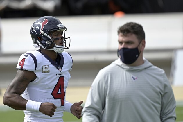 Houston Texans quarterback Deshaun Watson (4) warms up as offensive coordinator Tim Kelly watches before an NFL football game against the Jacksonville Jaguars, Sunday, Nov. 8, 2020, in Jacksonville, Fla. (AP Photo/Phelan M. Ebenhack)