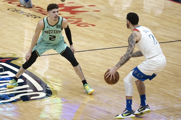 Charlotte Hornets guard LaMelo Ball (2) defends New Orleans Pelicans guard Lonzo Ball (2) in the second quarter of an NBA basketball game in New Orleans, Friday, Jan. 8, 2021. (AP Photo/Derick Hingle)