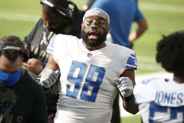 Detroit Lions defensive end Everson Griffen talks with teammates on the sideline during the first half of an NFL football game against the Minnesota Vikings, Sunday, Nov. 8, 2020, in Minneapolis. (AP Photo/Bruce Kluckhohn)