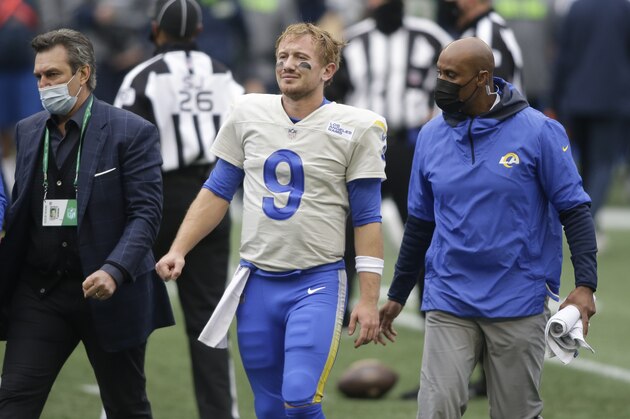 Los Angeles Rams quarterback John Wolford (9) walks off the field after being injured during the first half of an NFL wild-card playoff football game against the Seattle Seahawks, Saturday, Jan. 9, 2021, in Seattle. (AP Photo/Scott Eklund)