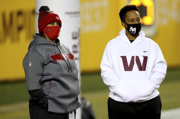 Tampa Bay Buccaneers defensive line coach Lori Locust and Washington Football Team coaching intern Jennifer King in action before an NFL wild-card playoff football game against the Tampa Bay Buccaneers, Saturday, Jan. 9, 2021 in Landover, Md. (AP Photo/Daniel Kucin Jr.)