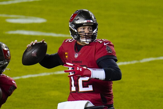 Tampa Bay Buccaneers quarterback Tom Brady (12) looks for a receiver during the first half of the team's NFL wild-card playoff football game against the Washington Football Team, Saturday, Jan. 9, 2021, in Landover, Md. (AP Photo/Julio Cortez)