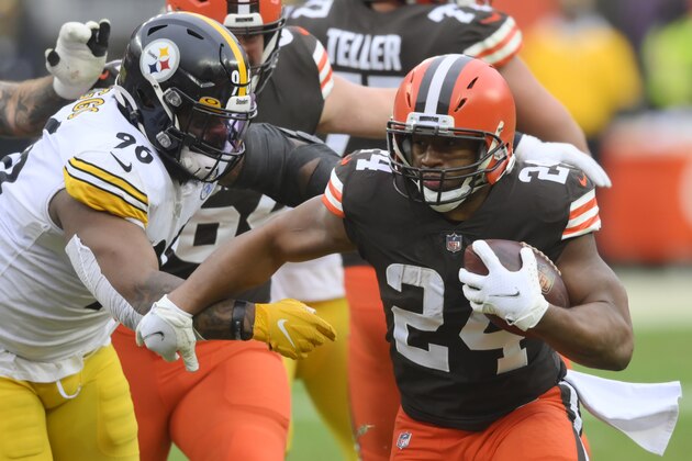 Cleveland Browns running back Nick Chubb (24) rushes against Pittsburgh Steelers defensive end Isaiah Buggs (96) during the first half of an NFL football game, Sunday, Jan. 3, 2021, in Cleveland. (AP Photo/David Richard)