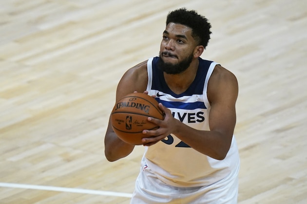 Minnesota Timberwolves center Karl-Anthony Towns (32) shoots a foul shot during the second half of an NBA basketball game against the Utah Jazz Saturday, Dec. 26, 2020, in Salt Lake City. (AP Photo/Rick Bowmer)