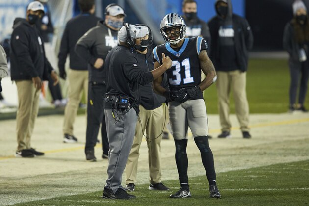 Carolina Panthers defensive pass game coordinator Jason Simmons talks to safety Juston Burris (31) during an NFL football game against the New Orleans Saints, Sunday, Jan. 3, 2021, in Charlotte, N.C. (AP Photo/Brian Westerholt)