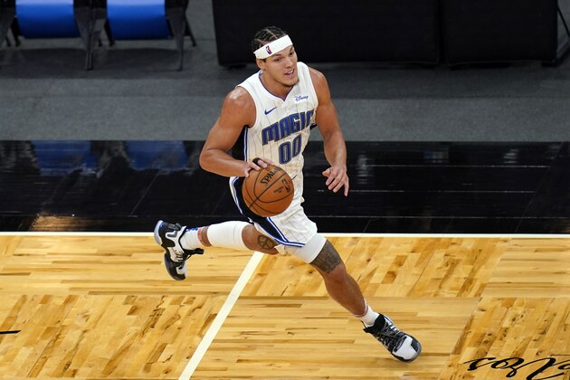 Orlando Magic forward Aaron Gordon moves the ball against the Cleveland Cavaliers during the second half of an NBA basketball game, Monday, Jan. 4, 2021, in Orlando, Fla. (AP Photo/John Raoux)