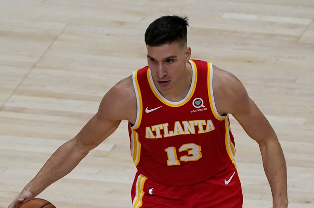 Atlanta Hawks guard Bogdan Bogdanovic (13) works against the Charlotte Hornets during the second half of an NBA basketball game Wednesday, Jan. 6, 2021, in Atlanta. (AP Photo/John Bazemore)