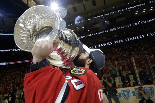 FILE - In this June 15, 2015, file photo, Chicago Blackhawks' goalie Corey Crawford kisses the Stanley Cup Trophy after defeating the Tampa Bay Lightning in Game 6 of the NHL hockey Stanley Cup Final series in Chicago. The past few weeks have seen several recent Stanley Cup winners get rid of members of their championship core. The Blackhawks moved on from Corey Crawford, the Washington Capitals did the same with Braden Holtby, the Pittsburgh Penguins traded fellow goalie Matt Murray and forward Patric Hornqvist and the St. Louis Blues signing Torey Krug means captain Alex Pietrangelo will sign elsewhere.  (AP Photo/Nam Y. Huh, File)