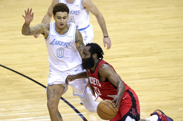 James Harden #13 of the Houston Rockets drives around Kyle Kuzma #0 of the Los Angeles Lakers during the third quarter of a game at Toyota Center on January 10, 2021 in Houston.  (Carmen Mandato/Pool Photo via AP)