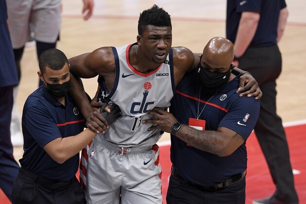 Washington Wizards center Thomas Bryant (13) is helped off the court after he was injured during the first half of an NBA basketball game against the Miami Heat, Saturday, Jan. 9, 2021, in Washington. (AP Photo/Nick Wass) Washington Wizards center Thomas Bryant (13) is helped off the court after he was injured during the first half of an NBA basketball game against the Miami Heat, Saturday, Jan. 9, 2021, in Washington. (AP Photo/Nick Wass)
