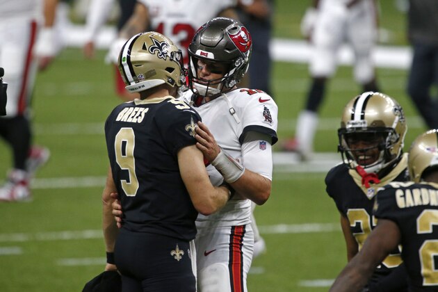 New Orleans Saints quarterback Drew Brees (9) and Tampa Bay Buccaneers quarterback Tom Brady hug after their season opening NFL football game in New Orleans, Sunday, Sept. 13, 2020. The Saints won 34-23. (AP Photo/Butch Dill)
