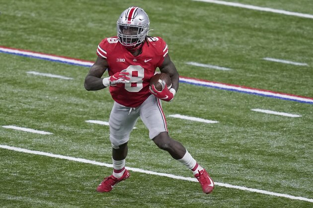 Ohio State running back Trey Sermon (8) runs with the ball during the second half of the Big Ten championship NCAA college football game against Northwestern, Saturday, Dec. 19, 2020, in Indianapolis. (AP Photo/Darron Cummings)