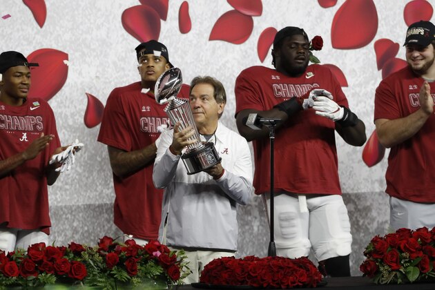 Alabama head coach Nick Saban holds the trophy after their win against Notre Dame in the Rose Bowl NCAA college football game in Arlington, Texas, Friday, Jan. 1, 2021. (AP Photo/Roger Steinman)