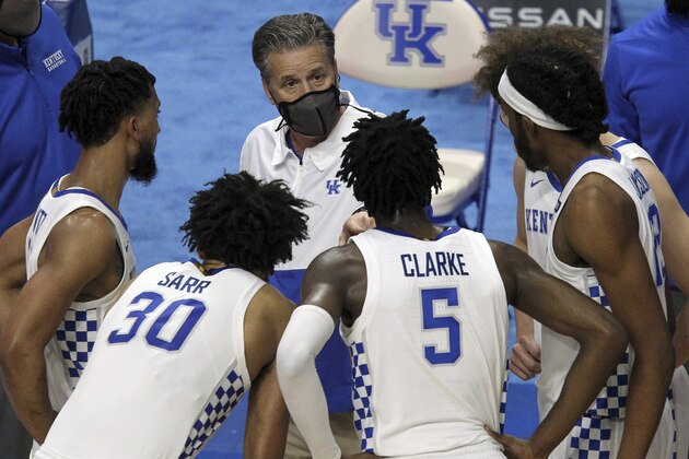 Kentucky head coach John Calipari, top center, instructs his team during a time out in the second half of an NCAA college basketball game against Notre Dame in Lexington, Ky., Saturday, Dec. 12, 2020. Notre Dame won 64-63. (AP Photo/James Crisp)