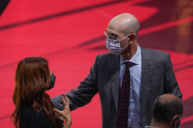 NBA Commissioner Adam Silver, right, speaks with a reporter after an interview before Game 3 of basketball's NBA Finals, Sunday, Oct. 4, 2020, in Lake Buena Vista, Fla. (AP Photo/Mark J. Terrill)