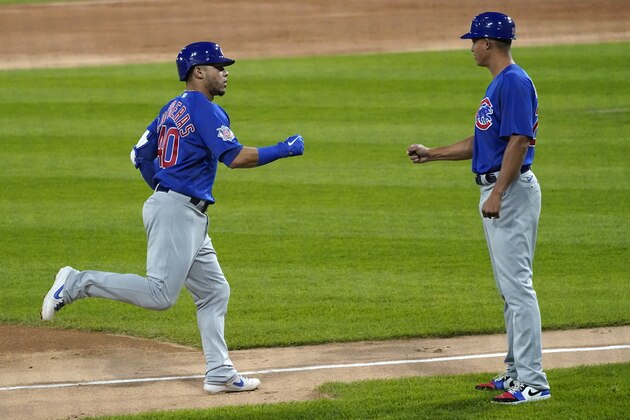 Chicago Cubs' Willson Contreras, left, celebrates with third base coach Will Venable as he rounds the bases after hitting a three-run home run during the third inning of a baseball game against the Chicago White Sox in Chicago, Friday, Sept. 25, 2020. (AP Photo/Nam Y. Huh)