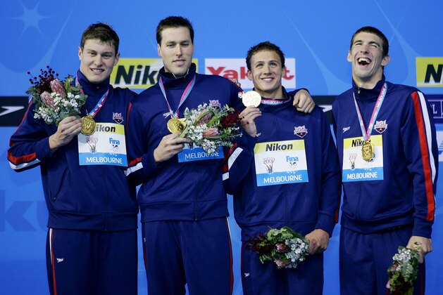 The USA Men's 4x200m Freestyle relay team members, from left, Peter Vanderkaay,  Klete Keller, Ryan Lochte and Michael Phelps celebrate after winning the gold medal at the World Swimming Championships in Melbourne, Australia, Friday, March 30, 2007.  (AP Photo/Mark Baker)
