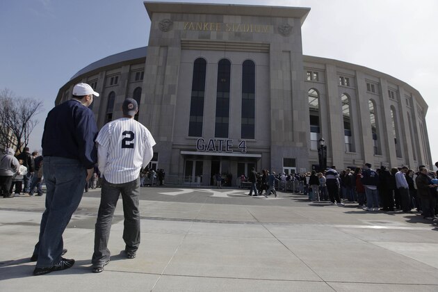 New York Yankee fans Sonny Gutic, left, and Jared Fritch look at the facade outside Gate 4 of the new Yankee Stadium before watching the Yankees work out Thursday, April 2, 2009, at the stadium in New York. (AP Photo/Julie Jacobson)