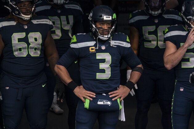 Seattle Seahawks quarterback Russell Wilson waits to take the field with teammates before an NFL wild-card playoff football game against the Los Angeles Rams, Saturday, Jan. 9, 2021, in Seattle. The Rams won 30-20. (AP Photo/Stephen Brashear)