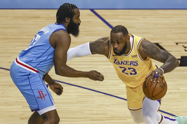 Los Angeles Lakers forward LeBron James (23) drives with the ball against Houston Rockets guard James Harden (13) during the first quarter of an NBA basketball game Tuesday, Jan. 21, 2021, in Houston. (Troy Taormina/Pool Photo via AP)