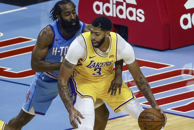 Los Angeles Lakers forward Anthony Davis (3) controls the ball against Houston Rockets guard James Harden during the third quarter of an NBA basketball game Tuesday, Jan. 21, 2021, in Houston. (Troy Taormina/Pool Photo via AP)