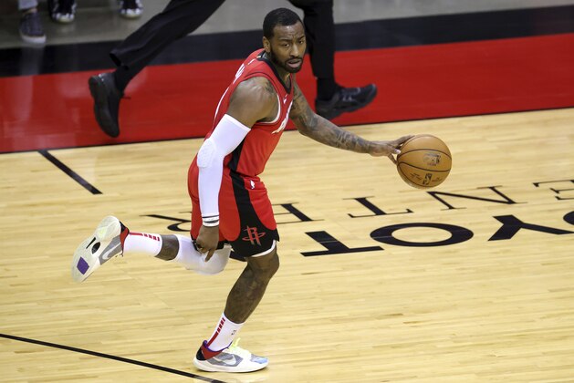 John Wall of the Houston Rockets takes the ball up court during the second quarter of an NBA basketball game Sunday, Jan. 10, 2021, in Houston, Texas. (Carmen Mandato/Pool Photo via AP)
