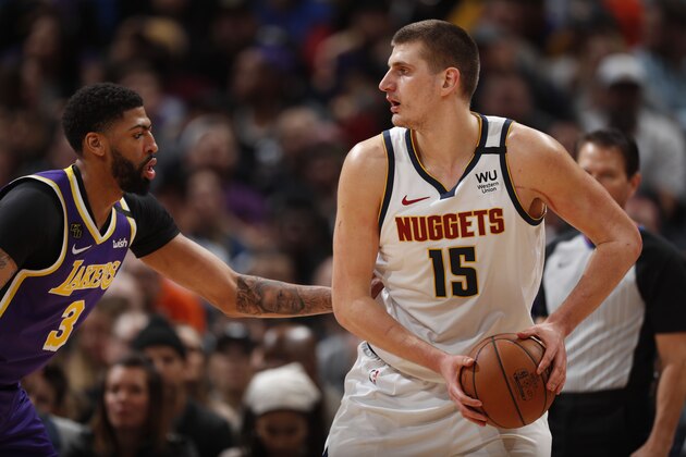 Los Angeles Lakers forward Anthony Davis (3) covers Denver Nuggets center Nikola Jokic (15) in the first half of an NBA basketball game Wednesday, Feb. 12, 2020, in Denver. (AP Photo/David Zalubowski)