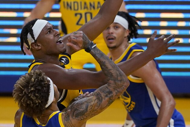 Indiana Pacers center Myles Turner, middle left, shoots next to Golden State Warriors guard Kelly Oubre Jr. (12) during the first half of an NBA basketball game in San Francisco, Tuesday, Jan. 12, 2021. (AP Photo/Jeff Chiu)