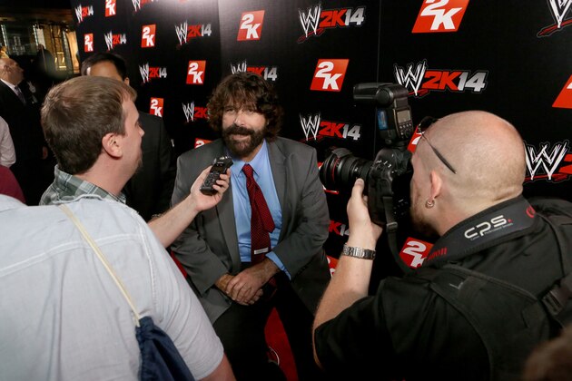 IMAGE DISTRIBUTED FOR 2K - WWE Hall of Famer Mick Foley talks with media at the WWE 2K14 press event, on Saturday, Aug. 17, 2013 in Los Angeles.  (Photo by Casey Rodgers/Invision for 2K/AP Images)