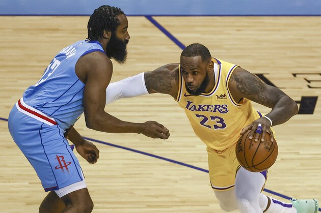 Los Angeles Lakers forward LeBron James (23) drives with the ball against Houston Rockets guard James Harden (13) during the first quarter of an NBA basketball game Tuesday, Jan. 21, 2021, in Houston. (Troy Taormina/Pool Photo via AP)