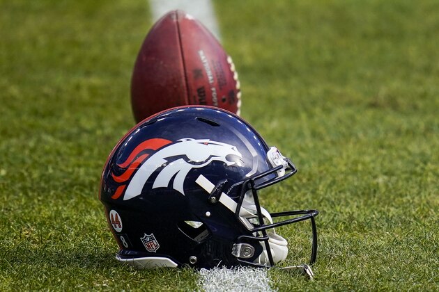 A Denver Broncos helmet sits on the field before an NFL football game between the Denver Broncos and the Las Vegas Raiders, Sunday, Jan. 3, 2021, in Denver. (AP Photo/Jack Dempsey)