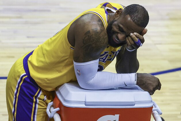 Los Angeles Lakers forward LeBron James reacts during a stop in play in the third quarter against the Houston Rockets in an NBA basketball game Tuesday, Jan. 21, 2021, in Houston. (Troy Taormina/Pool Photo via AP)